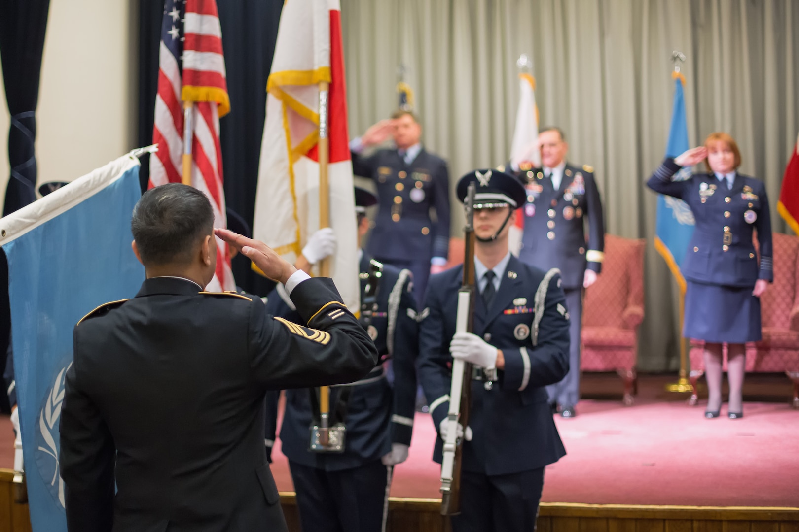 U.S. Army Master Sgt. Windy Ramel, left, United Nations Command (Rear) NCO in charge, salutes during the UNC (Rear) change of command ceremony at Yokota Air Base, Japan, Jan. 28, 2014. Royal Australian Air Force Group Capt. Barbara Courtney assumed command of the UNC (Rear), composed of eight nations accredited to the United Nations Command; Australia, Canada, France, New Zealand, the Philippines, Thailand, Turkey, and the United Kingdom of Great Britain. (U.S. Air Force photo by Osakabe Yasuo/Released)