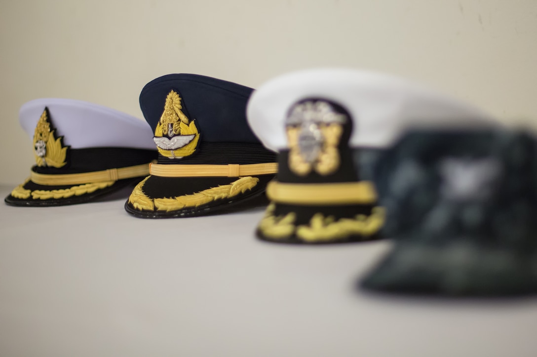 Attendees place their cover on the “hat table” outside the ballroom at Yokota Officers’ Club, Jan. 28, 2014, during the United Nations Command (Rear) change of command ceremony. Royal Australian Air Force Group Capt. Barbara Courtney assumed command of the UNC (Rear), composed of eight nations accredited to the United Nations Command; Australia, Canada, France, New Zealand, the Philippines, Thailand, Turkey, and the United Kingdom of Great Britain. (U.S. Air Force photo by Osakabe Yasuo/Released)