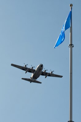 A C-130 Hercules flies over the United Nation flag at Yokota Air Base, Japan, Sept. 18, 2013. Yokota AB is one of the United Nation Command bases, under the UNC-Japan Status of Forces Agreement (SOFA) Decrees. (U.S. Air Force photo by Osakabe Yasuo/Released) 