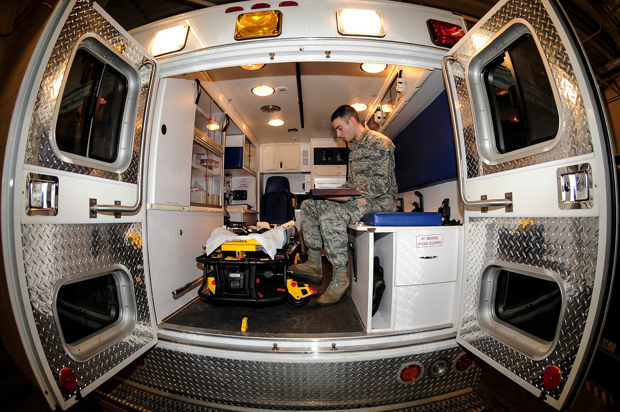 Senior Airman Jeremy Anderson, 354th Medical Operations Squadron ambulance crew member, reads through a checklist change-of-shift procedure Jan. 24, 2014, Eielson Air Force Base, Alaska. Ambulance crew members perform 24-hour on-call shifts on a rotational basis and must ensure the ambulance is properly inspected at each shift change. (U.S. Air Force photo by Senior Airman Zachary Perras/Released)