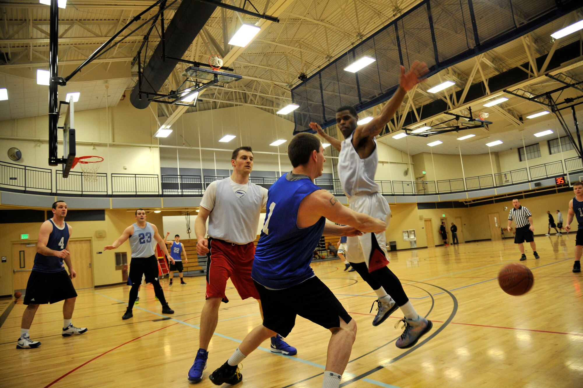 Members from the 92nd Force Support Squadron’s intramural basketball team block a member from the 336th Training Group’s team in the fitness center at Fairchild Air Force Base, Wash., Jan. 23, 2014. The 92nd FSS and 336th TRG are playing against each other in the final game of the championship. (U.S. Air Force photo by Airman 1st Class Ryan Zeski/Released)
