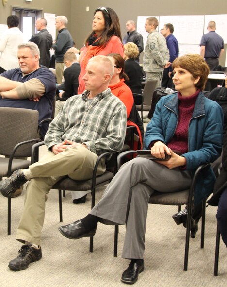 Lt. Col. Stephanie Boehning (far right) listens to a process improvement plan presentation during the AFSO21 Green Belt certification course held at Scott Air Force Base recently.  Those who attended were active duty, Air National Guard and Air Force Reserve members stationed at Scott Air Force Base.  The course was designed to teach participants how to cut out waste in their respective business processes. (Air Force photo/Staff Sgt. Meiko Schill.)