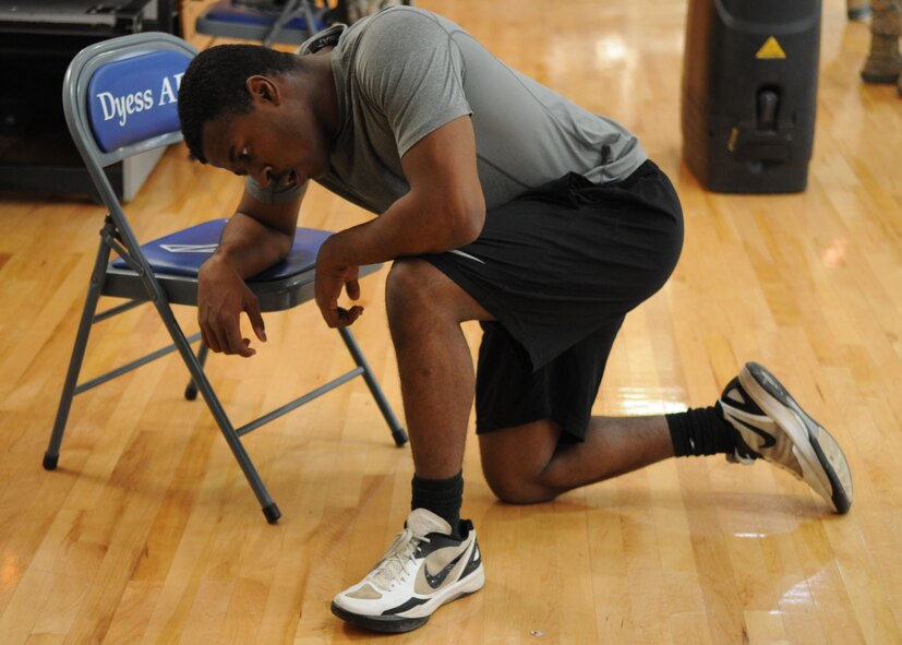 U.S. Air Force Airman 1st Class Andre Bradley, 7th Equipment Maintenance Squadron, rests after completing sprints Jan. 24, 2014, at Dyess Air Force Base, Texas. During this Warrior Challenge Bradley was timed on completing different exercises to include 100 repetitions of jump rope, 40 kettle bell swings, two sets of suicides and more. (U.S. Air Force photo by Senior Airman Shannon Hall/Released)