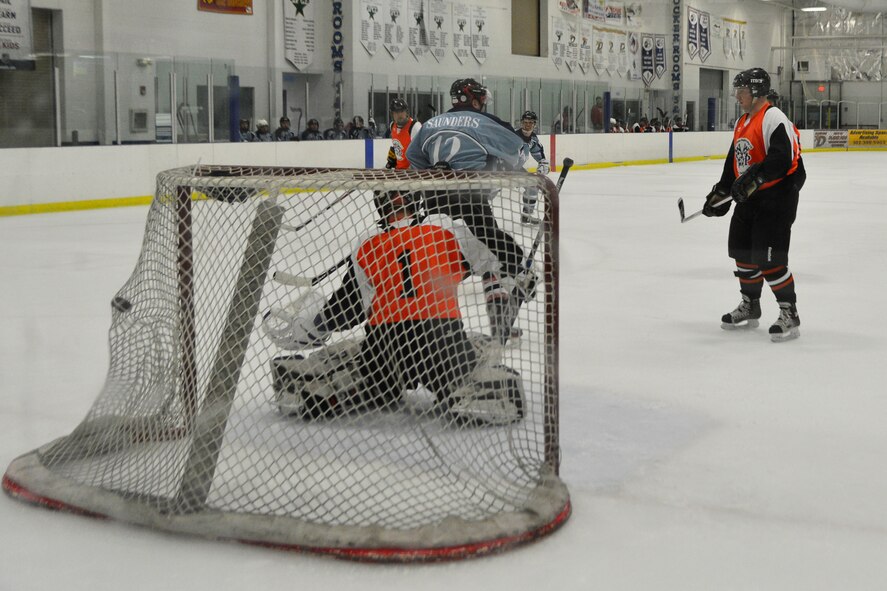John Dowgos, Dover Eagles defenseman, rips a shot into the net from the blue line during a charity hockey game Jan. 27, 2014, at the Centre Ice Rink in Harrington, Del. Dowgos scored two goals in the tying charity game to help benefit wounded police officers. (U.S. Air Force photos/Airman 1st Class William Johnson)