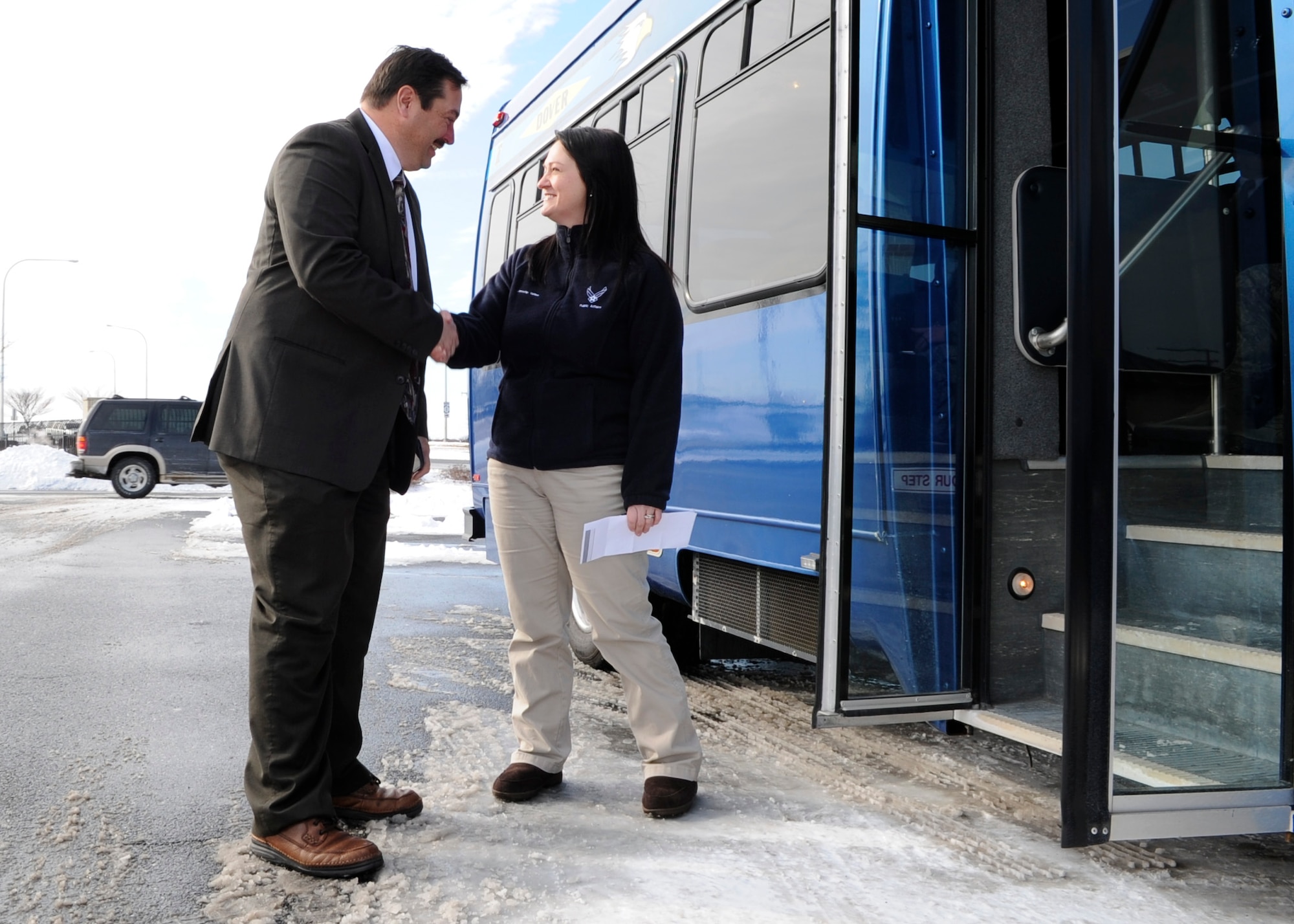 Jennifer Vallee, 436th Airlift Wing Public Affairs community relations chief, greets Charles Gray, Kent County Convention and Visitor’s Bureau director of sales, Jan. 23, 2014, at Dover Air Force Base, Del. Vallee won the 2013 Air Mobility Command Outstanding Communications Tactical Level Civilian Award. (U.S. Air Force photo/Airman 1st Class Zachary Cacicia) 