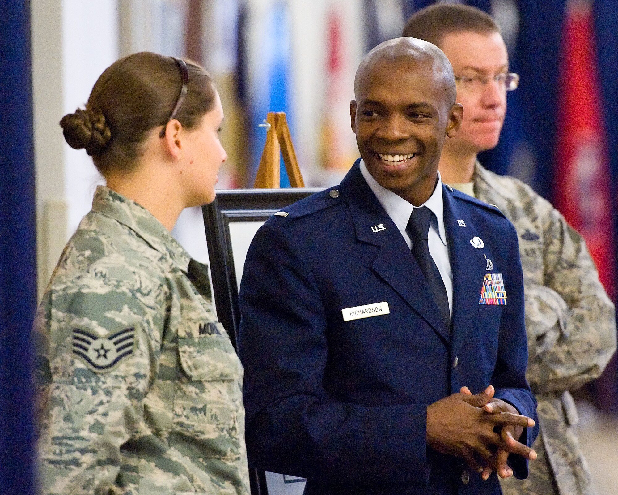 Then 1st Lt. Tony Richardson, 436th Airlift Wing Public Affairs chief, shares a light moment with Staff Sgt. Elizabeth Morris, 436th AW/PA photojournalist, at the Military Construction Breakfast Oct. 21, 2013, at The Landings on Dover Air Force Base, Del. Richardson said his award was more a reflection of the achievement of the PA office, rather than what he did on his own. (U.S. Air Force photo/Roland Balik)