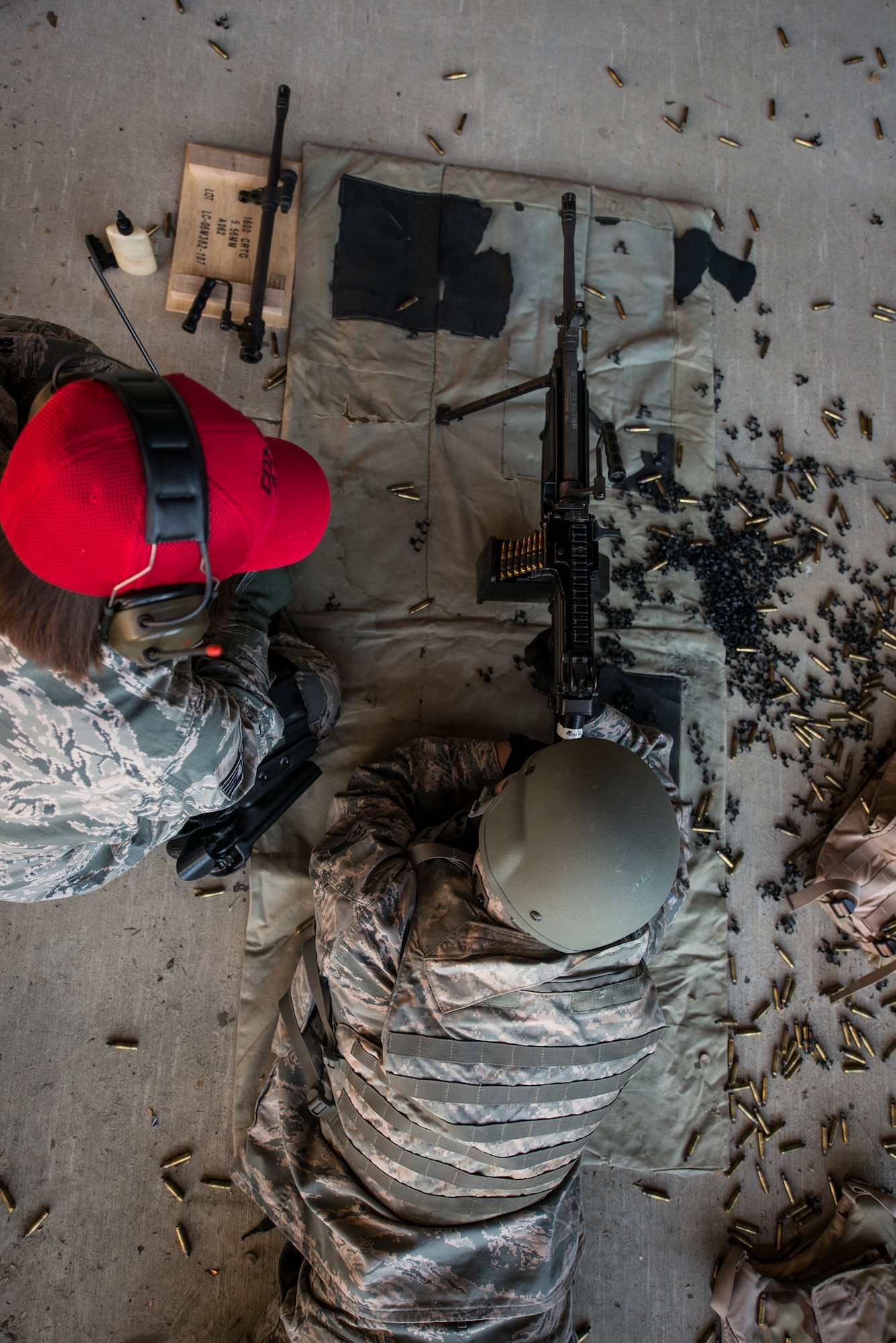 U.S. Air Force Staff Sgt. Chandi Alamos, left, 23d Security Forces Squadron combat arms training and maintenance (CATM) instructor, works with a CATM student at Moody Air Force Base, Ga., Jan. 22, 2014. Alamos is the assistant NCO in charge at Moody’s CATM range. (U.S. Air Force photo by Airman 1st Class Ryan Callaghan/Released)
