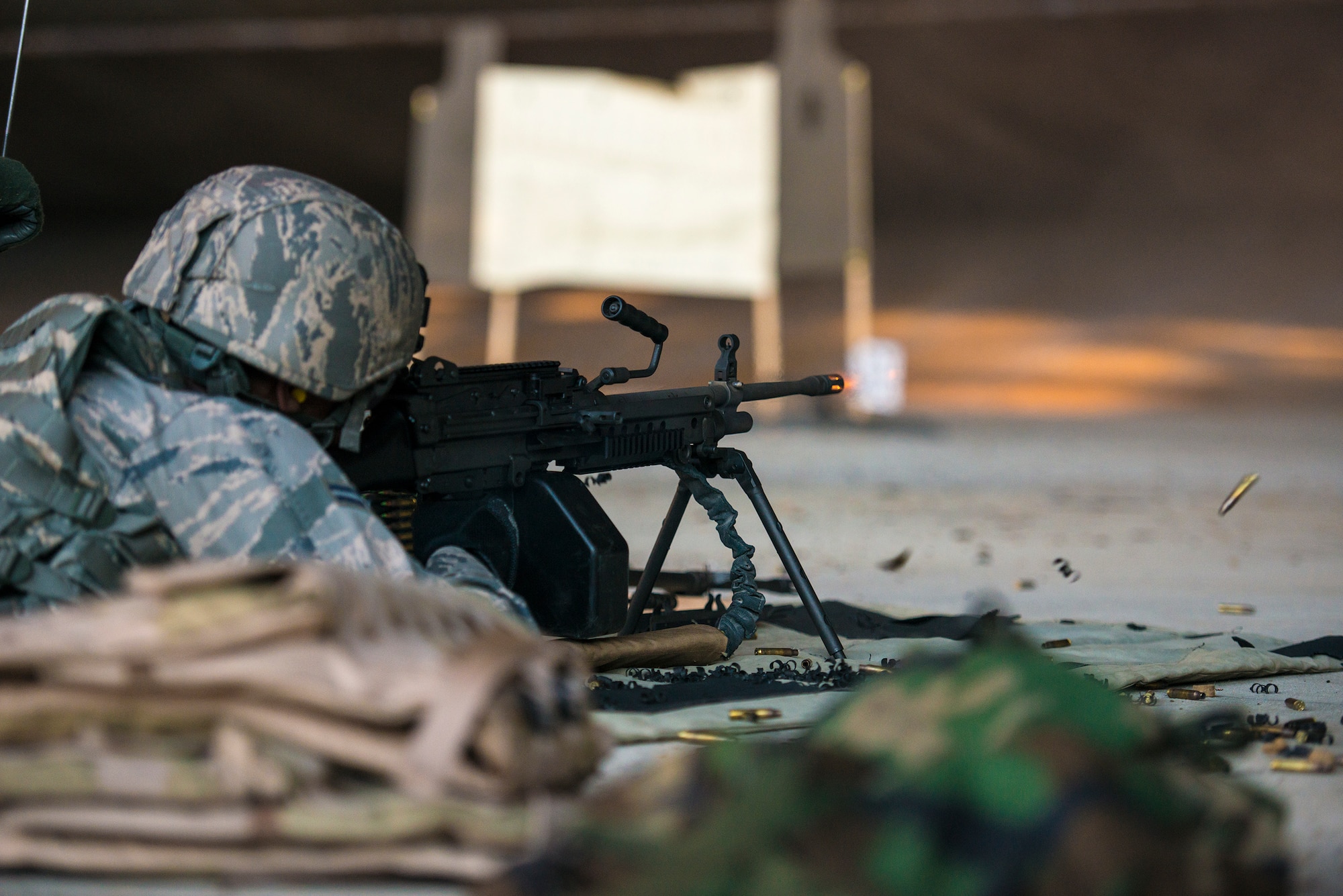 U.S. Air Force Airman 1st Class Nathaniel Northington, 23d Security Forces Squadron team member, fires an M249 light machine gun at Moody Air Force Base, Ga., Jan. 22, 2014. The M249 light machine gun has a sustained fire rate of 100 rounds per minute and a 700 meter point target effective firing range. (U.S. Air Force photo by Airman 1st Class Ryan Callaghan/Released)
