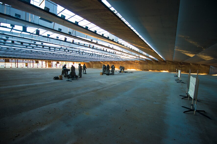 Airmen from the 23d Security Forces Squadron and instructors from the combat arms training and maintenance range set up for qualification firing at Moody Air Force Base, Ga., Jan. 22, 2014. Airmen shot at targets from a distance of ten meters for qualification on the M249 light machine gun. (U.S. Air Force photo by Airman 1st Class Ryan Callaghan/Released)
