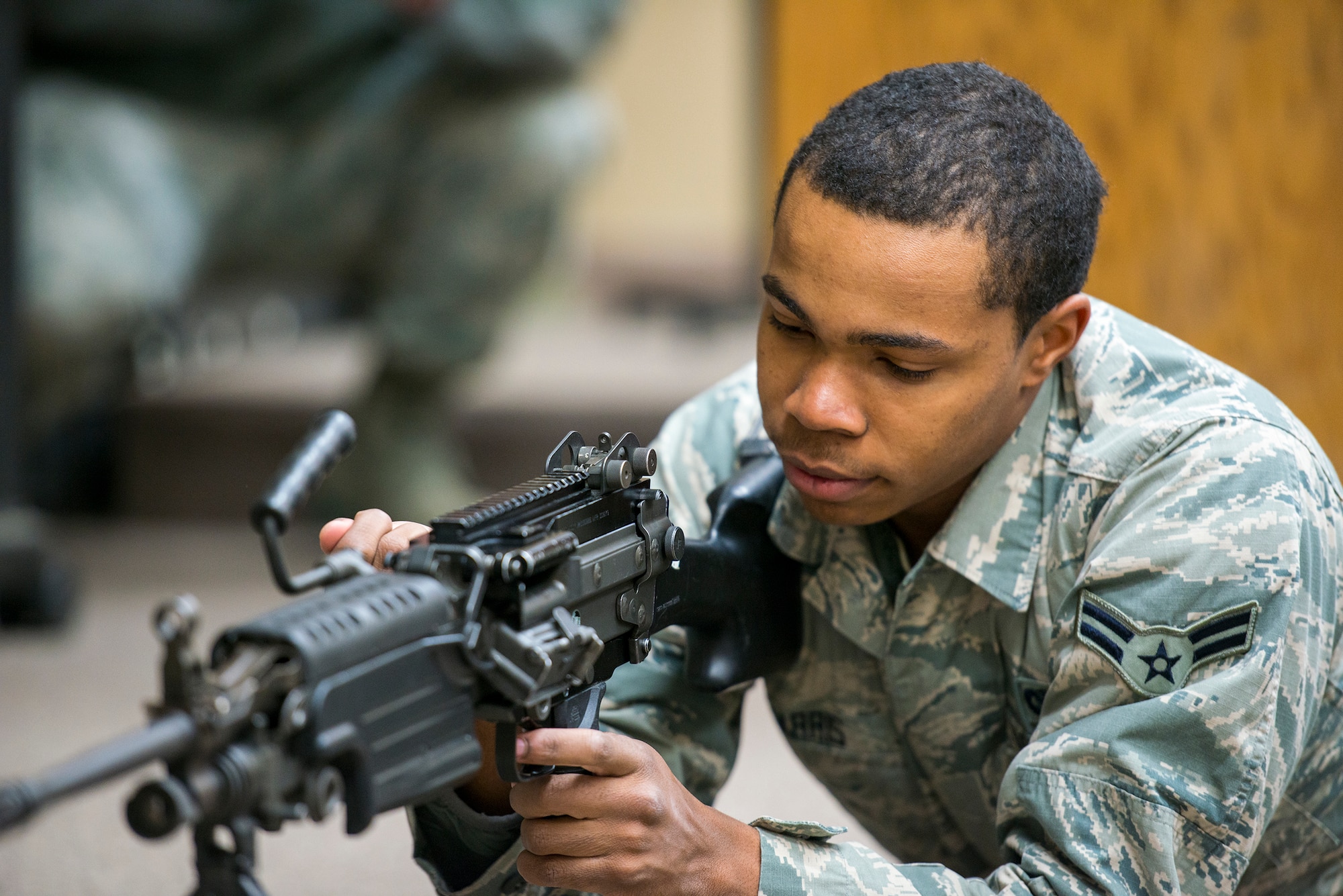U.S. Air Force Airman 1st Class James Harris, 23d Security Forces Squadron team member, demonstrates proper clearing procedures on an M249 light machine gun at Moody Air Force Base, Ga., Jan. 22, 2014. Prior to live-fire qualification, members of the 23d SFS attended formal classroom training to learn weapon teardown and cleaning. (U.S. Air Force photo by Airman 1st Class Ryan Callaghan/Released)
