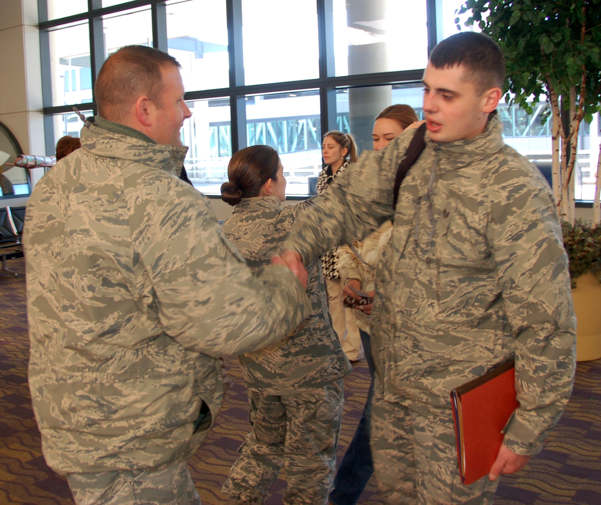 Maj. Douglas Scheirey, commander of the 103rd Force Support Squadron, shakes hands with Staff Sgt. Vitaliy Gorbachyk as he prepares to deploy to Southwest Asia with two fellow Airmen from the Bradley Air National Guard Base, East Granby, Conn. on Jan. 23, 2014.  (U.S. Air National Guard photo by Maj. Bryon M. Turner)
