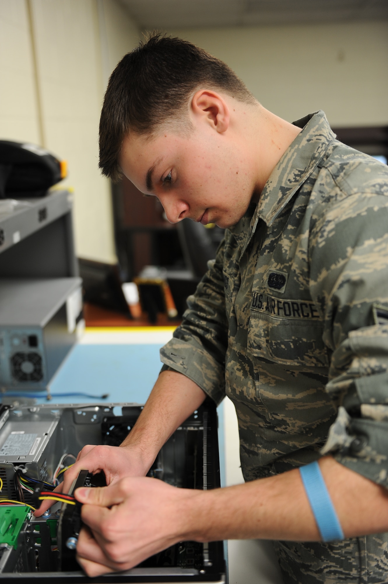 Airman 1st Class Nicholas Billing, a client systems technician with the 5th Communications Squadron here, rewires a hard drive at the Comm building on Minot Air Force Base, Jan. 22, 2014. Airmen in the 5th CS are responsible for maintaining and supporting base wide communication.  (U.S. Air Force photo/Airman 1st Class Lauren Pitts)