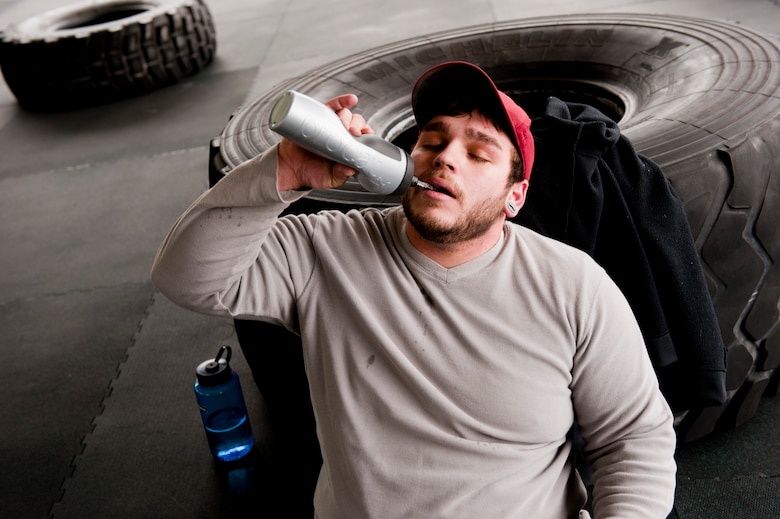 Michael Irby, a competitor at the King and Queen of the Gym, takes a break to hydrate at Hurlburt Field, Fla., Jan. 24, 2014. Participants completed three rounds of CrossFit exercises during the competition. (U.S. Air Force photo/Senior Airman Krystal M. Garrett)