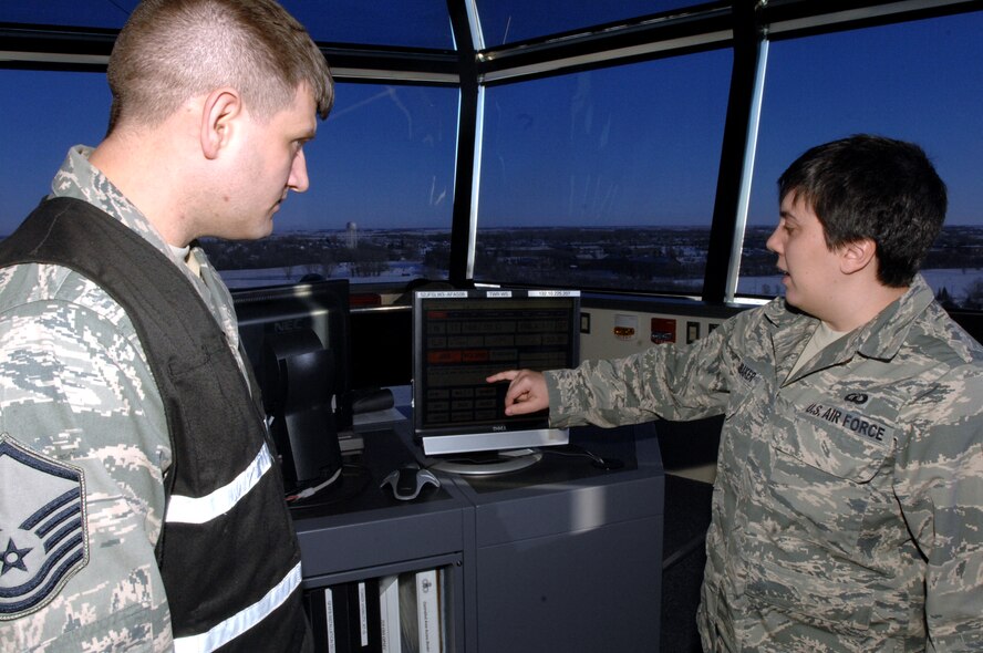 Senior Airman Lauren Hornbaker, 319th Operations Support Squadron air traffic control journeyman, gives a tour of the air control tower to Master Sgt. David Crawley, 319th Air Base Wing Inspector General Wing Inspection Team member Jan. 8, 2014 on Grand Forks AFB, N.D. The 319th Air Base Wing Inspector General office performed its first inspection recently under a new set of guidelines on the 319th Operations Support Squadron RAPCON tower. Crawley was named the Grand Forks Air Force Base Warrior of the Week for the first week of October 2014.(U.S. Air Force photo/Staff Sgt. Susan L. Davis) 
