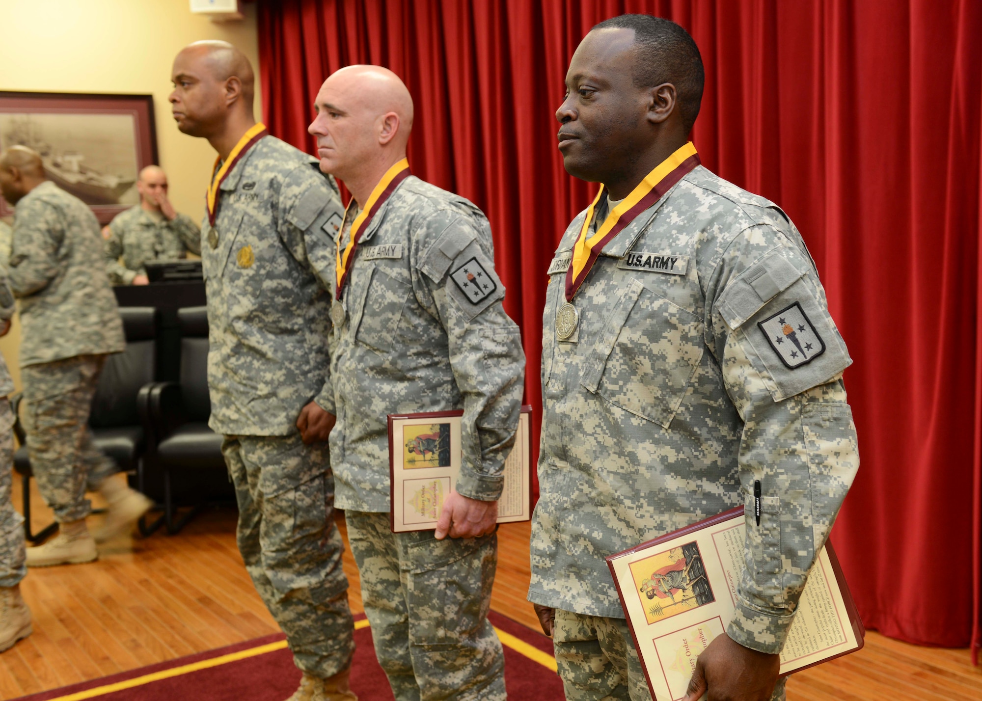 Recipients of the honorable Military Order of the Saint Christopher award stand at attention after receiving the award at Fort Eustis, Va., Jan. 28, 2014. Recipients of the award are recognized as outstanding transporters who signify outstanding contributions to the U.S. Army Transportation Corps. (U.S. Air Force photo by Staff Sgt. Ciara Wymbs/Released)