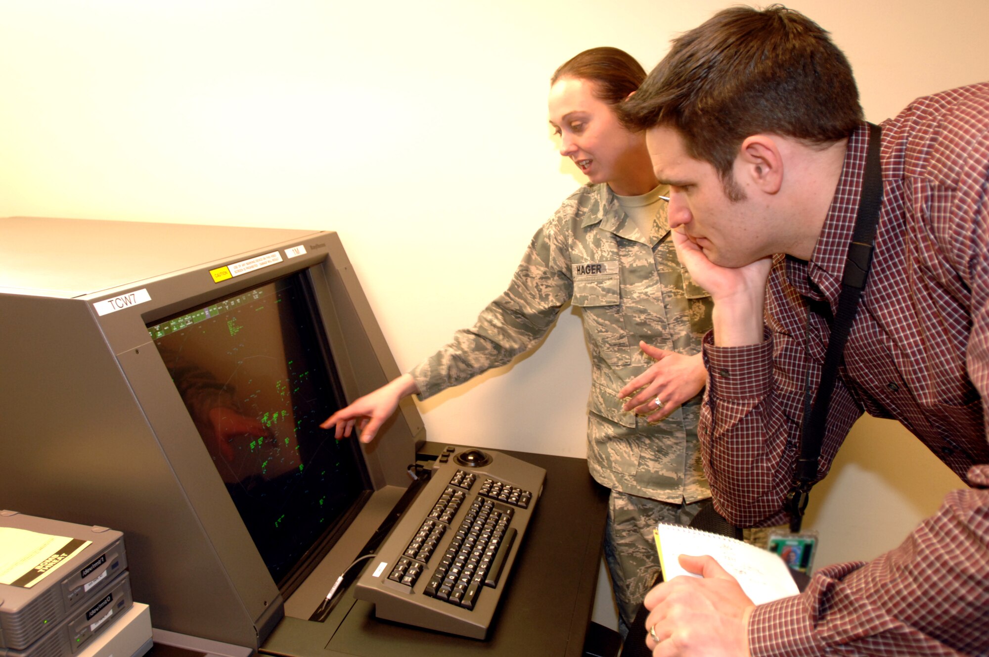 Master Sgt. Destiny Hager, 319th Operations Support Squadron Radar Approach and Control (RAPCON) chief controller, shows a TCW Radar display to Robert Zafke, 319th Air Base Wing Inspector General Wing Inspection Team member Jan. 8, 2013 on Grand Forks AFB, N.D. The 319th Air Base Wing Inspector General office performed its first inspection recently under a new set of guidelines on the 319th Operations Support Squadron RAPCON tower. (U.S. Air Force photo/Staff Sgt. Susan L. Davis)