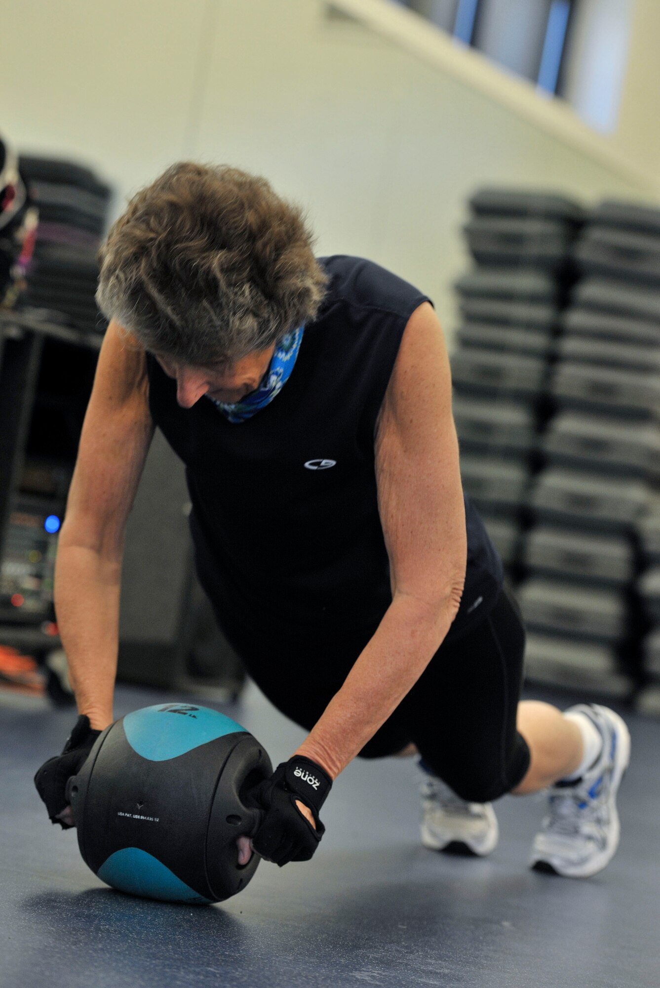 Janet Johnson, Full Body Sculpt Class student, works out with a medicine ball at Hurlburt Field, Fla., Jan. 23, 2014. Tuesdays are muscle-specific workouts extended in stations and Thursdays are circuit based workouts. (U.S. Air Force photo/Airmen 1st Class Andrea Posey)