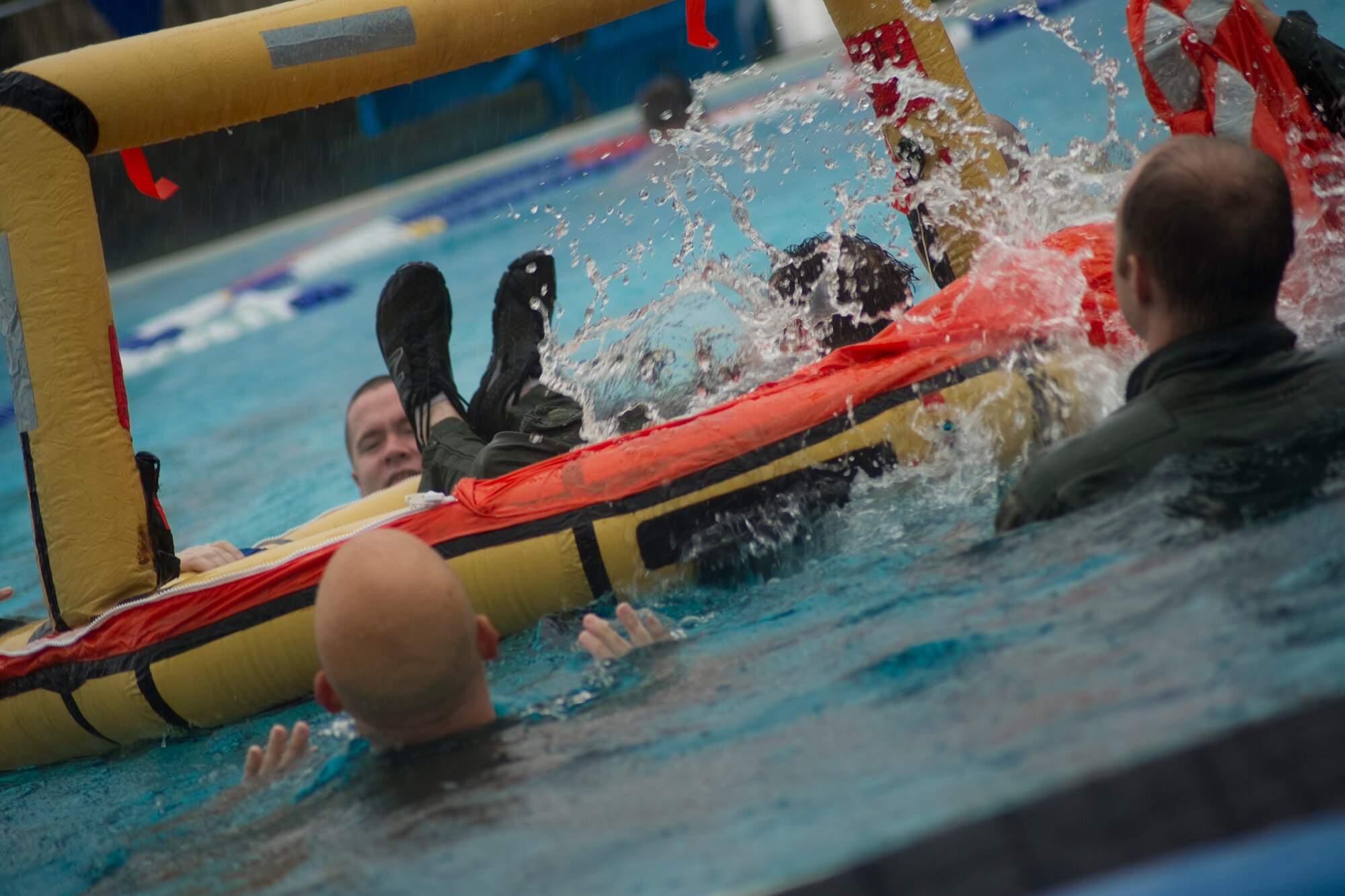 Aircrew members splash water inside a survival raft during a water-survival refresher course in the base pool at Hurlburt Field, Fla., Jan. 27 2014. All aircrew must stay current in survival, evasion, resistance and escape training to remain flight qualified. (U.S. Air Force photo/Senior Airman Naomi Griego) 