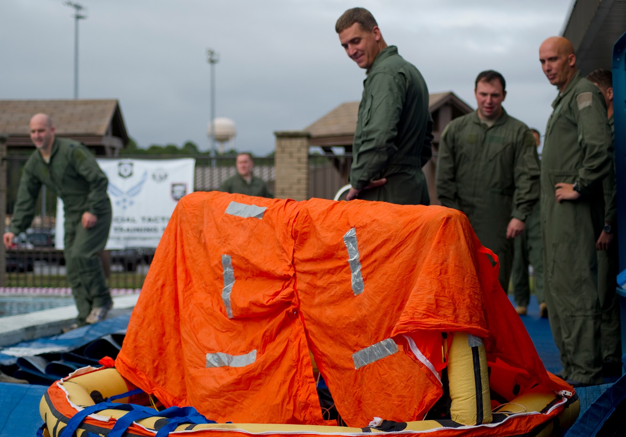 Airmen prepare for water-survival refresher training during a survival, evasion, resistance and escape class in the base pool at Hurlburt Field, Fla., Jan. 27 2014. The training provides aircrew knowledge to successfully escape a rotary-wing aircraft submerged in water. (U.S. Air Force photo/Senior Airman Naomi Griego)