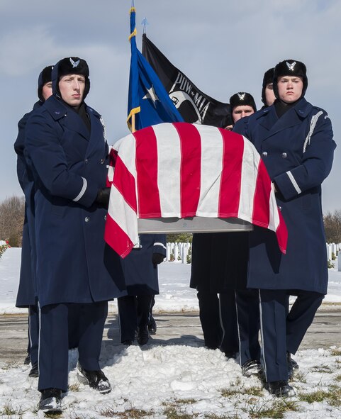 Pall bearers from the U.S. Air Force Honor Guard carry the casket of retired Brig. Gen. Robinson "Robbie" Risner to his gravesite during his internment ceremony at Arlington National Cemetery in Virginia on Jan. 23, 2014. Risner was the Air Force's 20th Ace and survived seven and a half years of captivity as a prisoner of war in Hoa Lo Prison, aka the Hanoi Hilton during the Vietnam War. (U.S. Air Force photo/Jim Varhegyi)