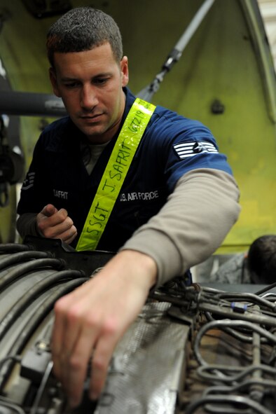 U.S. Air Force Staff Sgt. Justin Safrit, 718th Aircraft Maintenance Squadron integrated avionics craftsman, removes screws on the engine of a KC-135 Stratotanker during a Mission Focused Exercise on Kadena Air Base, Japan, Jan. 28, 2014. Members were tasked with replacing one of the KC-135 engines during the MFE in order to ensure their readiness for real-world contingencies. (U.S. Air Force photo by Airman 1st Class Zade C. Vadnais)