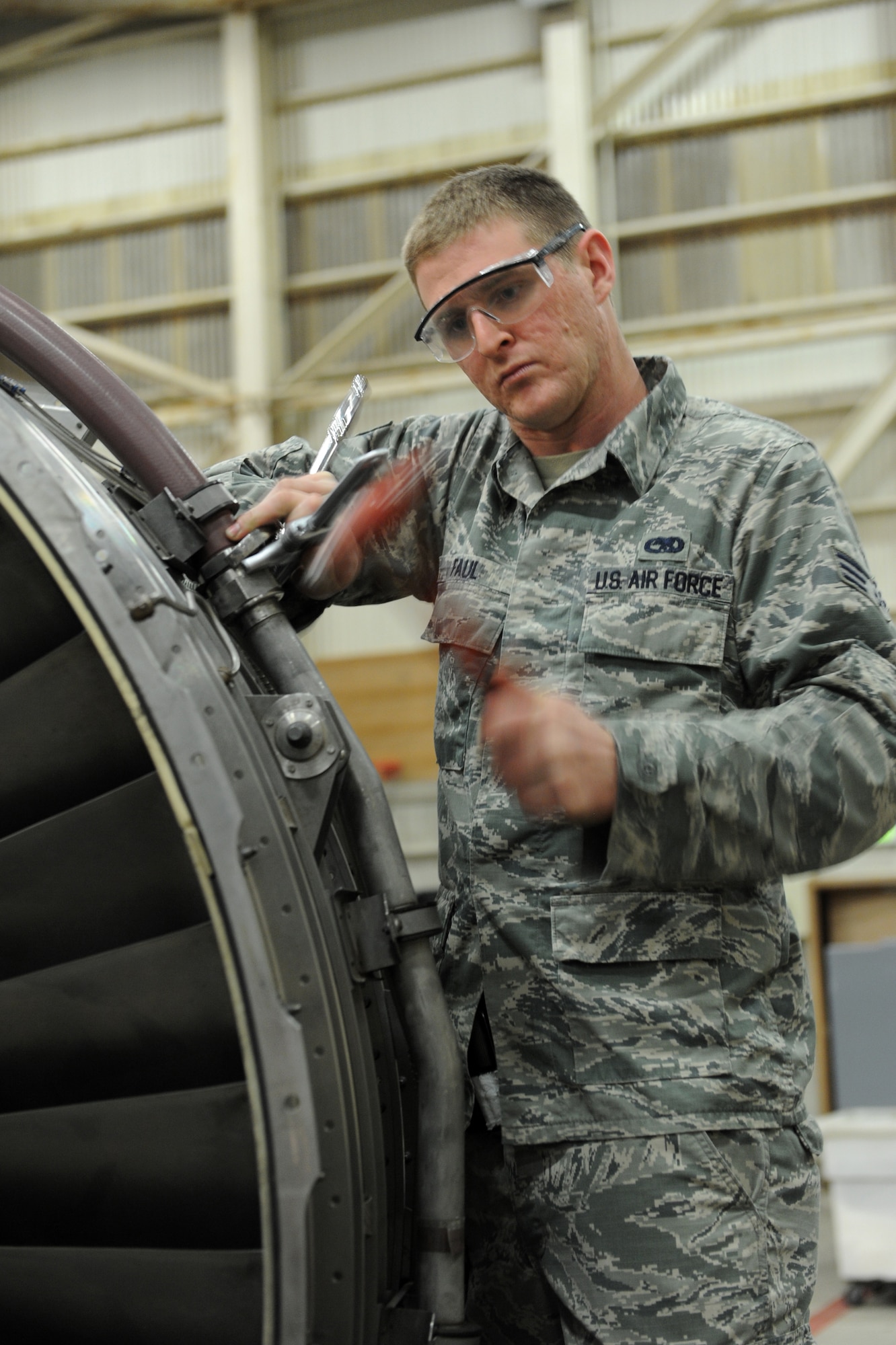 U.S. Air Force Senior Airman Brandon Faul, 718th Aircraft Maintenance Squadron integrated avionics apprentice, loosens a bolt on the engine of a KC-135 Stratotanker during a Mission Focused Exercise on Kadena Air Base, Japan, Jan. 28, 2014. Airmen at the 718th AMXS were tasked with replacing the engine of a KC-135 Stratotanker during the MFE in order to test their preparedness for real-world contingencies. (U.S. Air Force photo by Airman 1st Class Zade C. Vadnais)