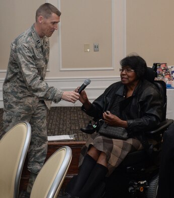 U.S. Air Force Chaplain (Capt.) Randy Croft, 20th Fighter Wing chaplain, hands the microphone to Ione Dwyer, City of Sumter councilwoman, at the Carolina Skies Club and Conference Center during the 20th FW Chapel’s deployed family dinner at Shaw Air Force Base, S.C., Jan. 27, 2014. Dwyer delivered words of gratitude from the city to all the Airmen and families of Airmen who are deployed from Shaw. (U.S. Air Force photo by Airman 1st Class Jonathan Bass/Released) 