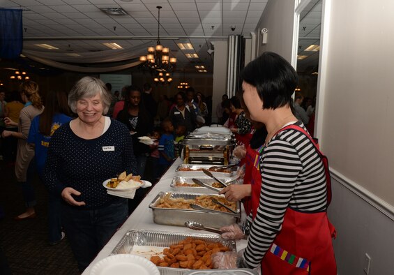 Families of deployed Shaw Airmen start to go through the dinner line at the Carolina Skies Club and Conference Center during the 20th Fighter Wing Chapel’s deployed family dinner at Shaw Air Force Base, S.C., Jan. 27, 2014. This month’s dinner was provided by the Korean Presbyterian Church in Sumter, S.C. (U.S. Air Force photo by Airman 1st Class Jonathan Bass/Released) 