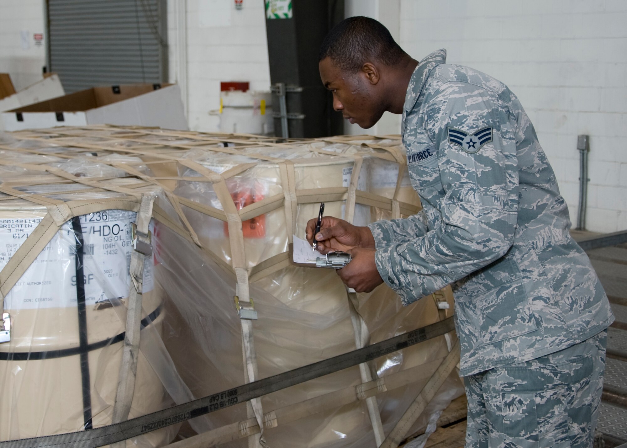 Senior Airman Stephen Yelbert, 436th Comptroller Squadron all things financial specialist, checks the air readiness of a pallet Jan. 23, 2014, at the 436th Aerial Port Squadron on Dover Air Force Base, Del. Yelbert said working with the 436th APS has helped him to understand the Air Force’s mission better. (U.S. Air Force photo/Senior Airman Jared Duhon)