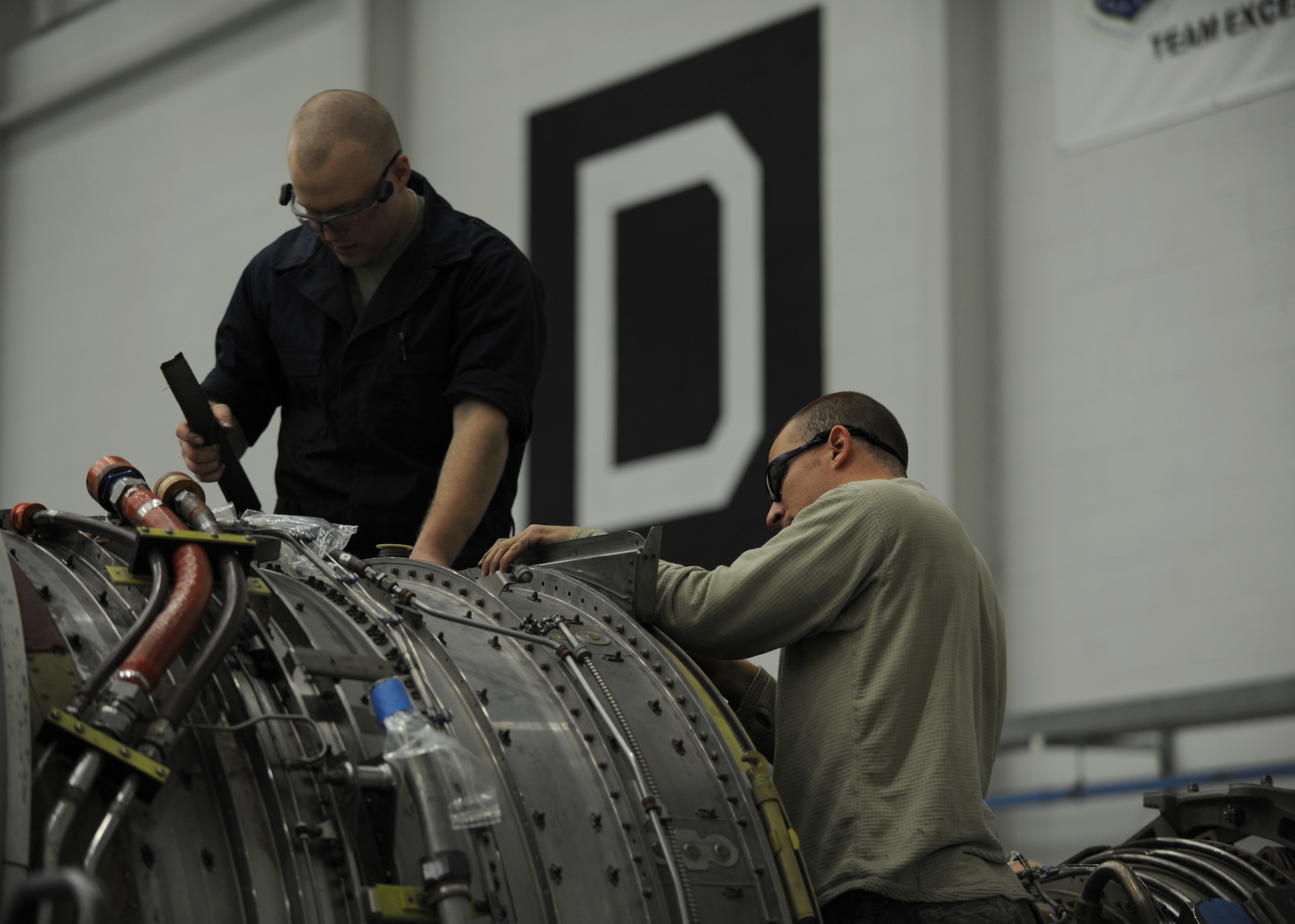 U.S. Air Force Senior Airman Jake Waslosky, left, 100th Maintenance Squadron aerospace propulsion journeyman from Houtzdale, Penn., and U.S. Air Force Senior Airman Brent Walters, right, 100th Maintenance Squadron aerospace propulsion journeyman from Fraser, Mich., configure a KC-135 Stratotanker engine prior to attaching it to an aircraft Jan. 24, 2014, on RAF Mildenhall, England. To ensure the engine is mounted properly, Airmen swapped aircraft-specific parts from one engine to another rather than risk damaging or destroying them by forcing the engines to fit a new aircraft.  (U.S. Air Force photo by Airman 1st Class Preston Webb/Released)