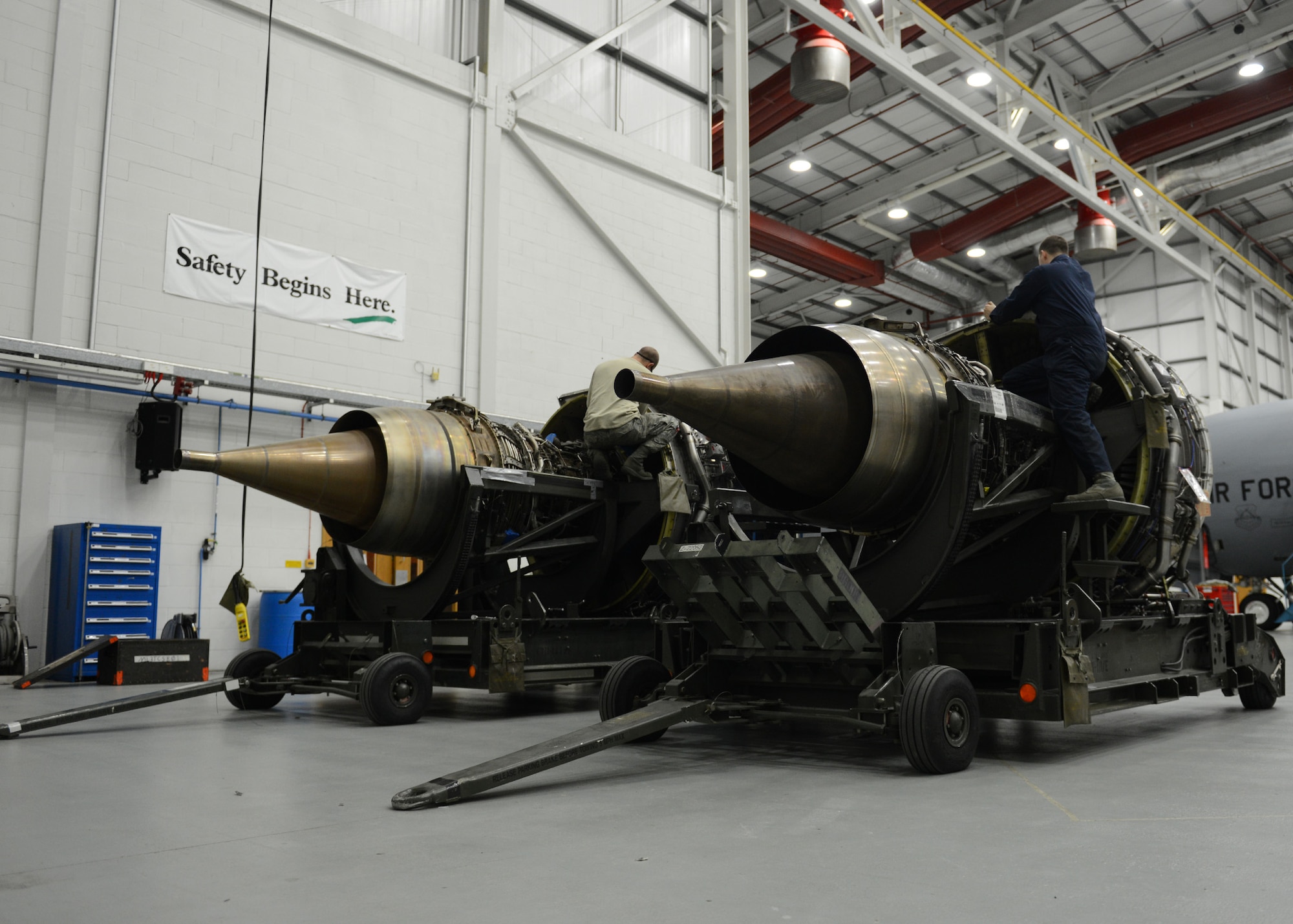 Team Mildenhall maintainers change aircraft-specific parts between two KC-135 Stratotanker engines Jan. 24, 2014, on RAF Mildenhall, England. Airmen replaced the original engine because it had damaged fan blades. They sent the original engine to the U.S. where it will be repaired and rebuilt into a new engine. (U.S. Air Force photo by Airman 1st Class Preston Webb/Released)