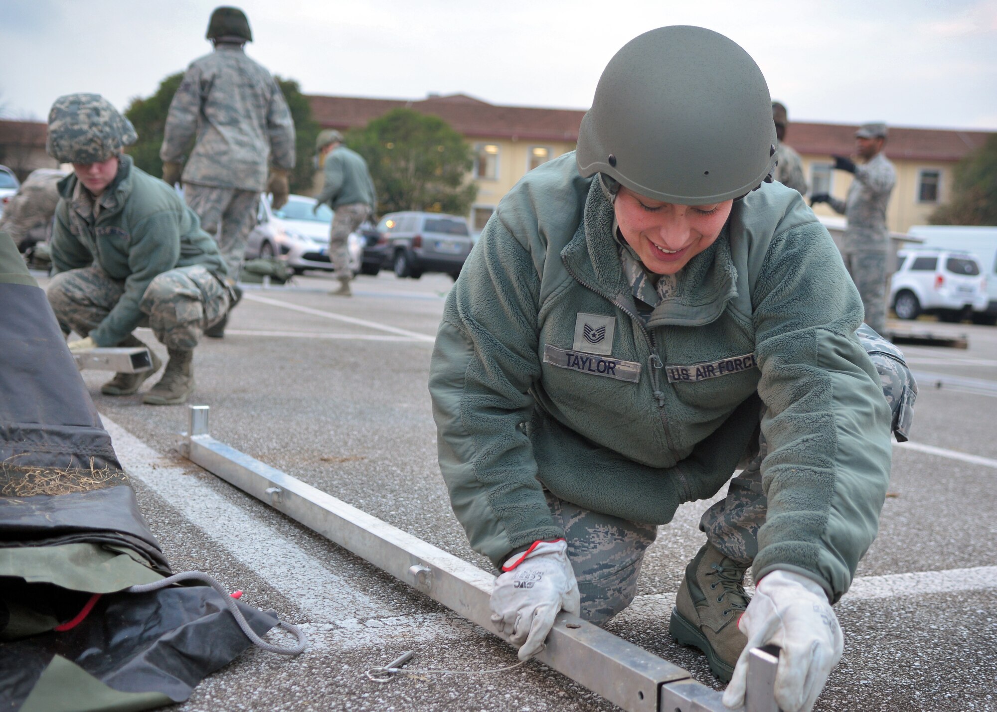 Tech. Sgt. Lizandra Taylor, 31st Force Support Squadron La Dolce Vita assistant manager, connects metal framing for a tent, Jan. 23, 2014, at Aviano Air Base, Italy. To better prepare for the upcoming wing inspection, Airmen from the 31st FSS participated in a crisis-response exercise that tested their ability to provide emergency services to an influx of personnel. (U.S. Air Force photo/Senior Airman Briana Jones)