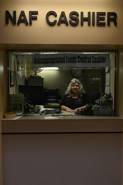 Brenda Kaziska, 20th Force Support Squadron non-appropriated funds central cashier, poses for a photo at Shaw Air Force Base, S.C., Jan. 27, 2014. Kaziska works behind a one inch protective glass window because she handles multiple FSS deposits of thousands of dollars. (U. S. Air Force photo by Airman 1st Class Jensen Stidham/Released) 