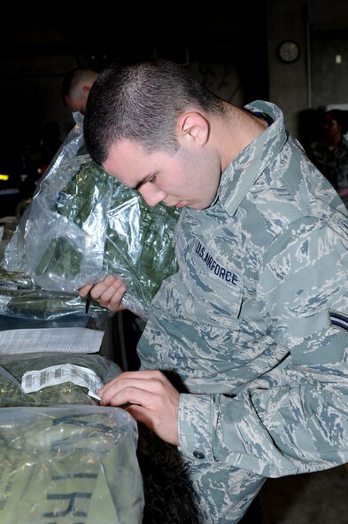 U.S. Air Force Airman 1st Class Justin Ivey, 18th Component Maintenance Squadron aircraft fuel systems technician, fills out paperwork for individual protective equipment during a Mission Focused Exercise on Kadena Air Base, Japan, Jan. 28, 2014. Personnel who are tasked to deploy from here receive IPE from the 18th Logistics Readiness Squadron before departing to locations at risk of becoming a chemical environment. (U.S. Air Force photo by Airman 1st Class Hailey R. Staker)
