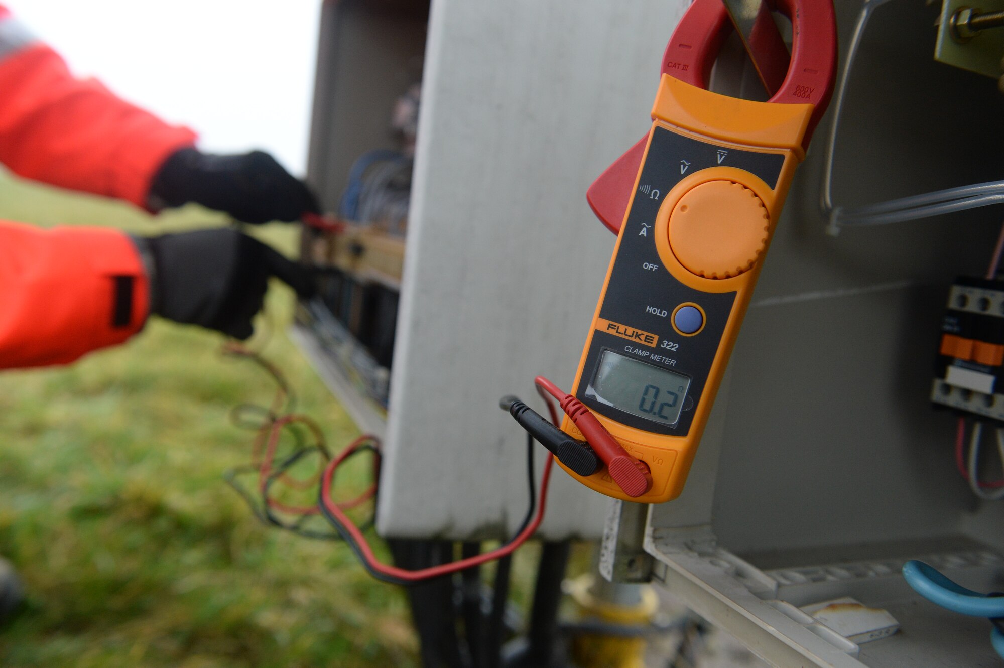 A multi-meter is displayed as U.S. Air Force Senior Airman Aaron Demmon, a 52nd Civil Engineer Squadron electrical systems journeyman from  Ludington, Mich., checks voltage on a circuit breaker on the airfield at Spangdahlem Air Base, Germany, Jan. 23, 2014. Demmon used the multi-meter to figure out a solution for a broken strobe light. (U.S. Air Force photo by Senior Airman Rusty Frank/Released)