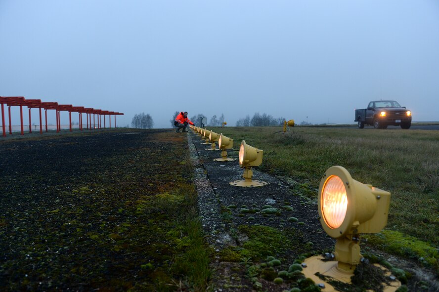 U.S. Air Force Senior Airman Aaron Demmon, a 52nd Civil Engineer Squadron electrical systems journeyman from Ludington, Mich., inspects strobe lights on the airfield at Spangdahlem Air Base, Germany, Jan. 23, 2014. Demmon and his two other team members inspect all the lights on the airfield to include the runway, and all taxi ways. (U.S. Air Force photo by Senior Airman Rusty Frank/Released)