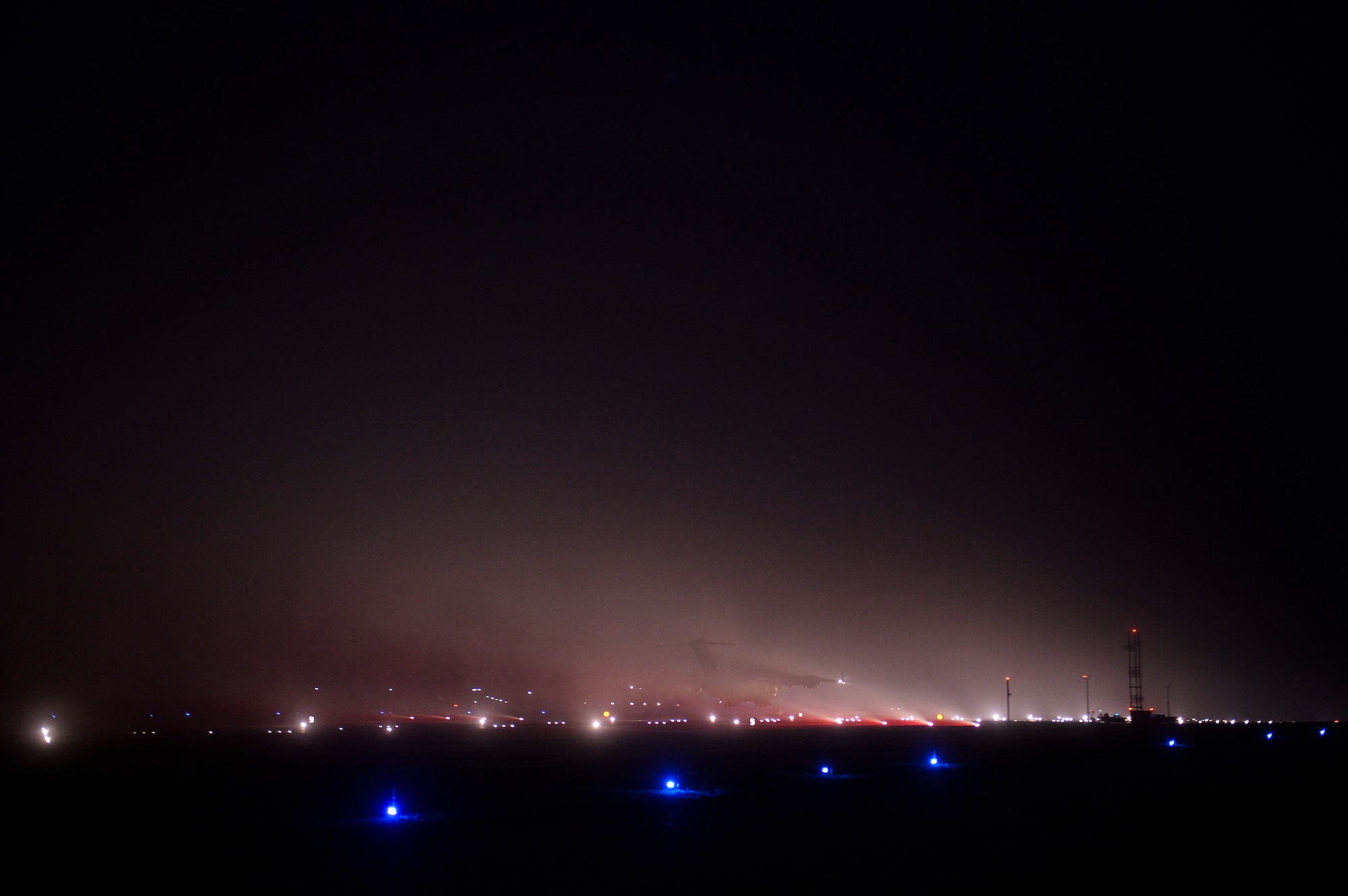 A C-17 Globemaster lands on the flightline at Spangdahlem Air Base, Germany, Jan. 23, 2014. Dealing with the weather conditions and approaching and departing aircraft are one of the many challenges that members of the 52nd Civil Engineer Squadron airfield lighting face every day. (U.S. Air Force photo by Senior Airman Rusty Frank/Released)