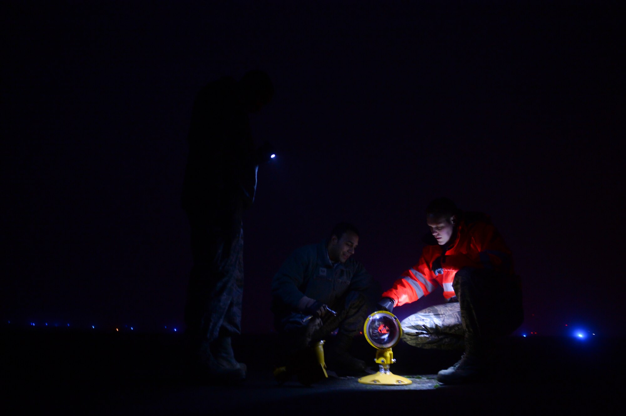 Members of the 52nd Civil Engineer Squadron airfield lighting inspect a broken  strobe on the airfield at Spangdahlem Air Base, Germany Jan. 23, 2014. Members of the 52nd CES airfield lighting inspect all the lights on the airfield every day. (U.S. Air Force photo by Senior Airman Rusty Frank/Released)