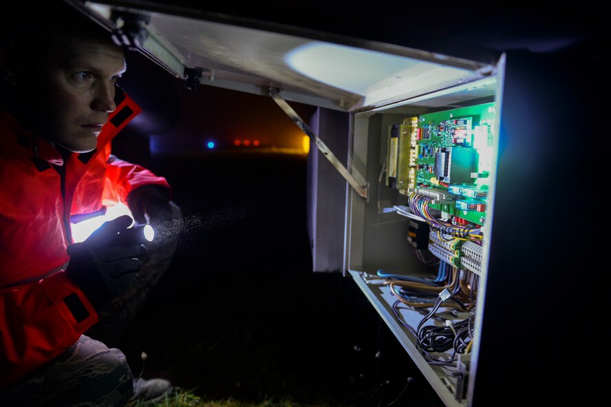 U.S. Air Force Senior Airman Aaron Demmon, a 52nd Civil Engineer Squadron electrical systems journeyman from Ludington, Mich., checks a circuit panel on for maintenance on a strobe light on the airfield at Spangdahlem Air Base, Germany Jan. 23, 2014. Demmon checked the circuit panel to find a way to troubleshoot a broken strobe on the airfield. (U.S. Air Force photo by Senior Airman Rusty Frank/Released)