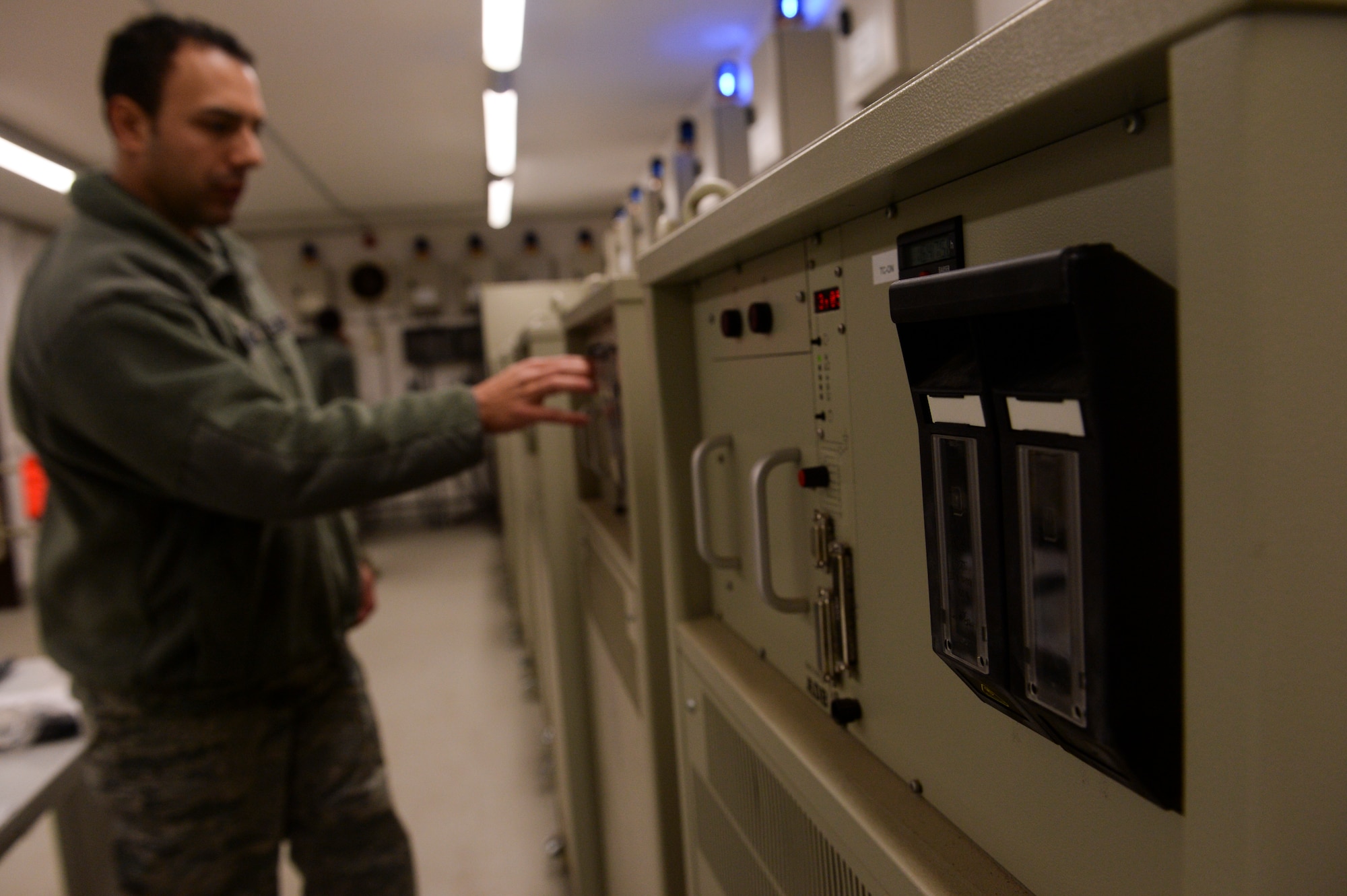 U.S. Air Force Staff Sgt. Roberto Rodriguez, a 52nd Civil Engineer Squadron electrical systems Craftsman from, Marion, Ohio, checks a constant current regulator prior to checking the lights on the airfield at Spangdahlem Air Base, Germany, Jan. 23, 2014. The CCR's ensure that the lights on the airfield receive constant power. (U.S. Air Force photo by Senior Airman Rusty Frank/Released)