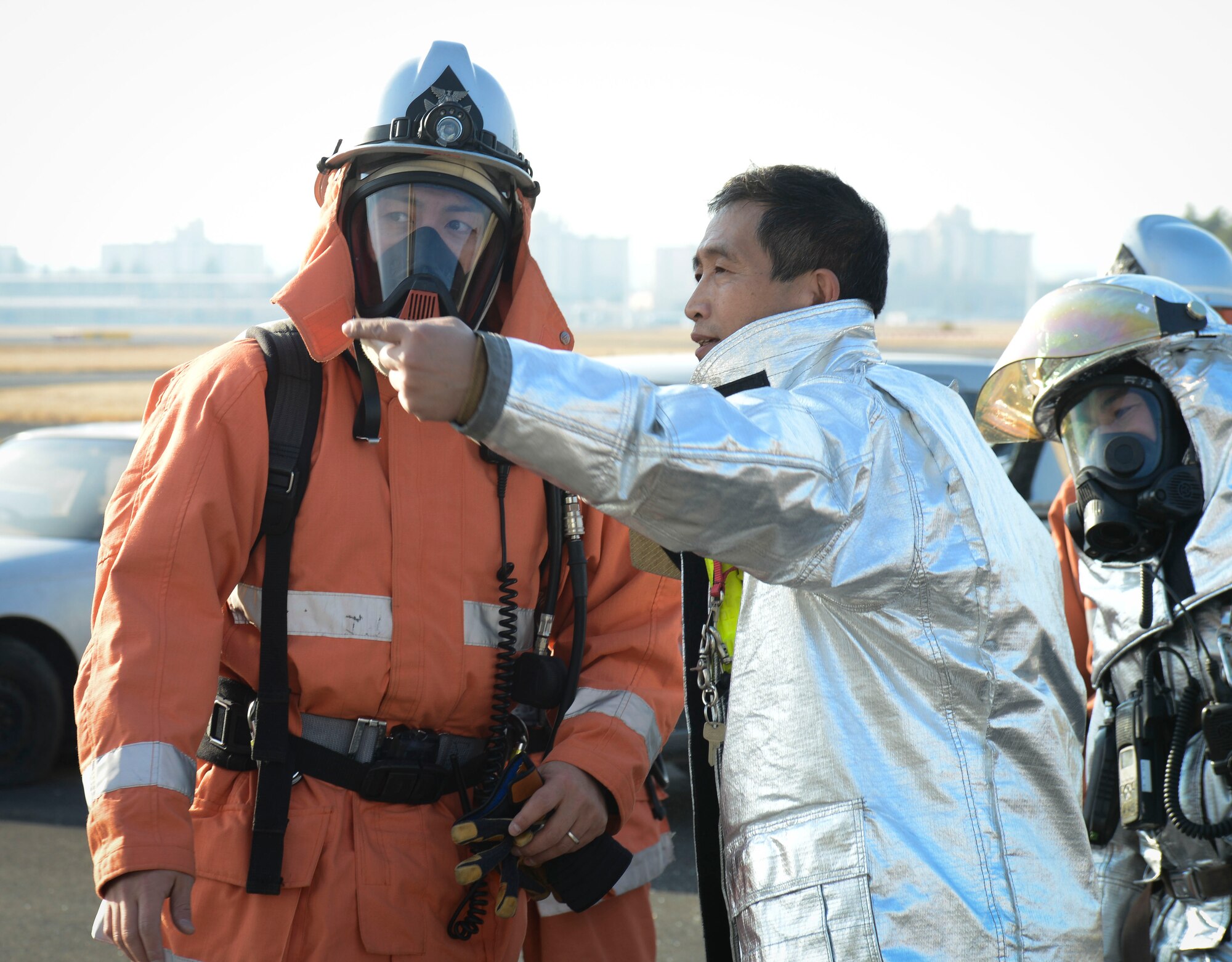 Kazuyuki Kasuya, a firefighter from the 374th Civil Engineering Squadron,
translates orders to a firefighter with the Japan Air Self-Defense Force at
Yokota Air Base, Japan, Jan. 23, 2014.  Bilateral partnership is crucial to
ensure the safety of the community. (U.S. Air Force photo by Airman 1st
Class Meagan Schutter/Released)