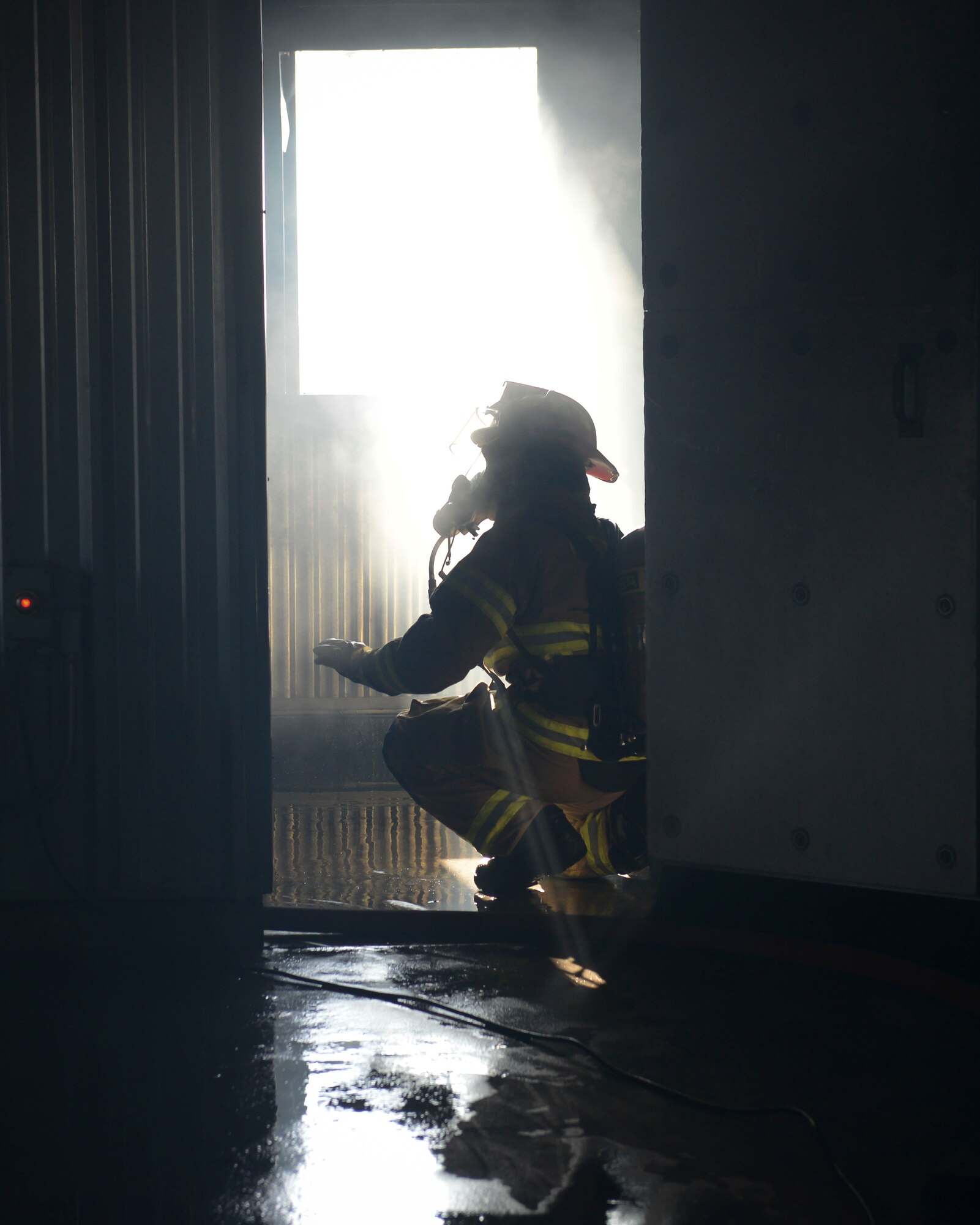 Staff Sgt. Stanley Lynn, 374th Civil Engineering Squadron crew chief,
supervises and ensures there is proper ventilation as fellow firefighters
extinguish a propane fire as part of a structural fire burn training
exercise at Yokota Air Base, Japan, Jan. 23, 2014.  Ventilation is important
for a survivable atmosphere to allow the super heated gases and smoke to
escape the facility. (U.S. Air Force photo by Airman 1st Class Meagan
Schutter/Released)