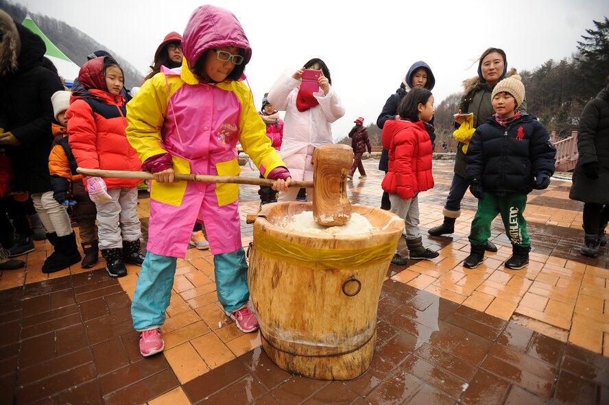 Tteok, a traditional Korean desert, is made by mashing rice flour with a mallet, pictured here Jan. 25, 2014,  in Taebaek, Republic of Korea. Once the tteok has been mashed to a fine paste, it's then powdered and eaten. (U.S. Air Force photo by Staff Sgt. Jake Barreiro)