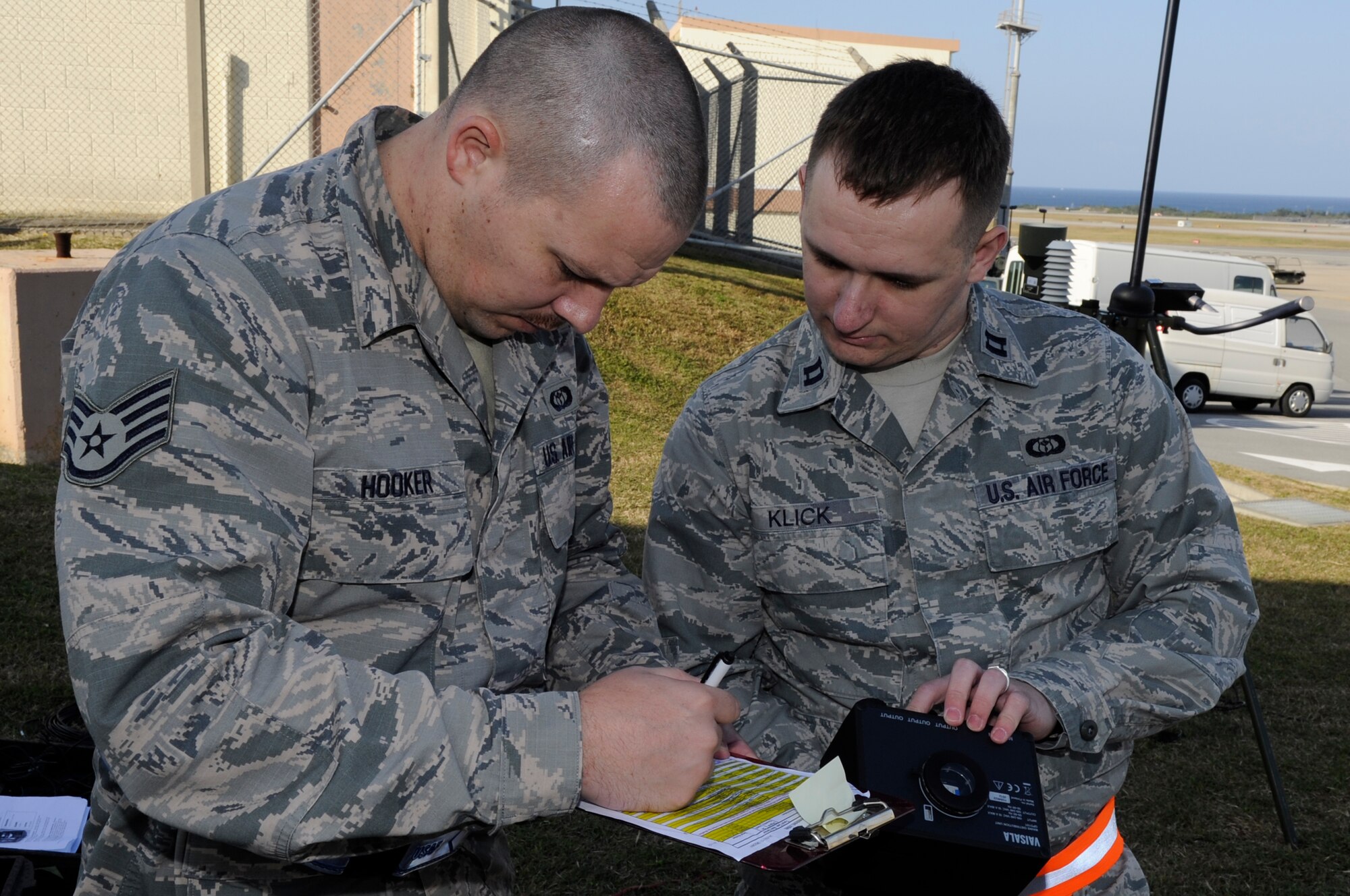 U.S. Air Force Staff Sgt. Chad Hooker, 18th Operations Support Squadron weather forecaster, and Capt. Matthew Klick, 18th OSS weather flight commander, verify the inventory log for a tactical meteorological observation system during a Mission Focused Exercise on Kadena Air Base, Japan, Jan. 28, 2014. The system assists war planners and combat weather teams through a collection of weather sensors connected to a computer. (U.S. Air Force photo by Senior Airman Marcus Morris)