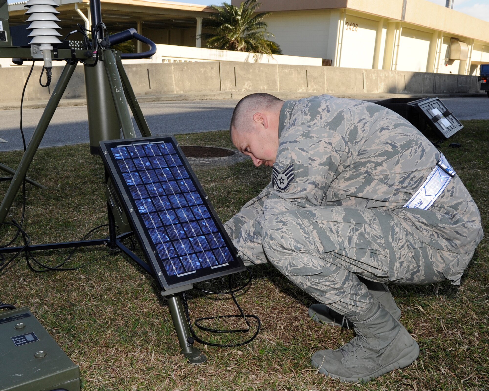 U.S. Air Force Staff Sgt. Chad Hooker, 18th Operations Support Squadron weather forecaster, sets up a tactical meteorological observation system during a Mission Focused Exercise on Kadena Air Base, Japan, Jan. 28, 2014. The system uses low-earth orbiting satellites to collect data, enabling the transmission of mission-critical weather data within an hour. (U.S. Air Force photo by Senior Airman Marcus Morris)
