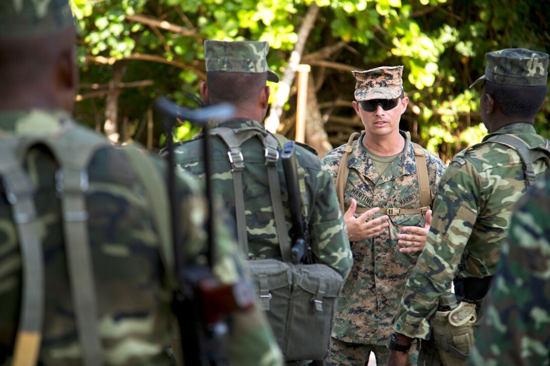 U.S. Marine Corps Master Sgt. John Martinez, center, speaks with Maldivian marines after live-fire training on the island of Maafilaafushi, Maldives, Jan. 26, 2014. Martinez is assigned to Mobile Training Team, U.S. Marine Corps Forces, Pacific.