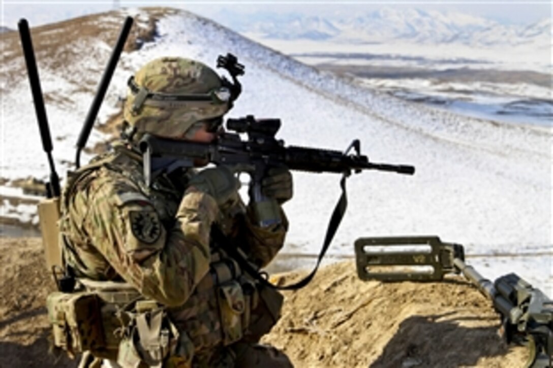 U.S. Army Spc. Nickolas Evangelista-Reitner scans the area while providing overwatch security for another unit in Ghazni province, Afghanistan, Jan. 22, 2014. Evangelista-Reitner is assigned to U.S. Army National Guard's 216th Mobile Augmentation Company.