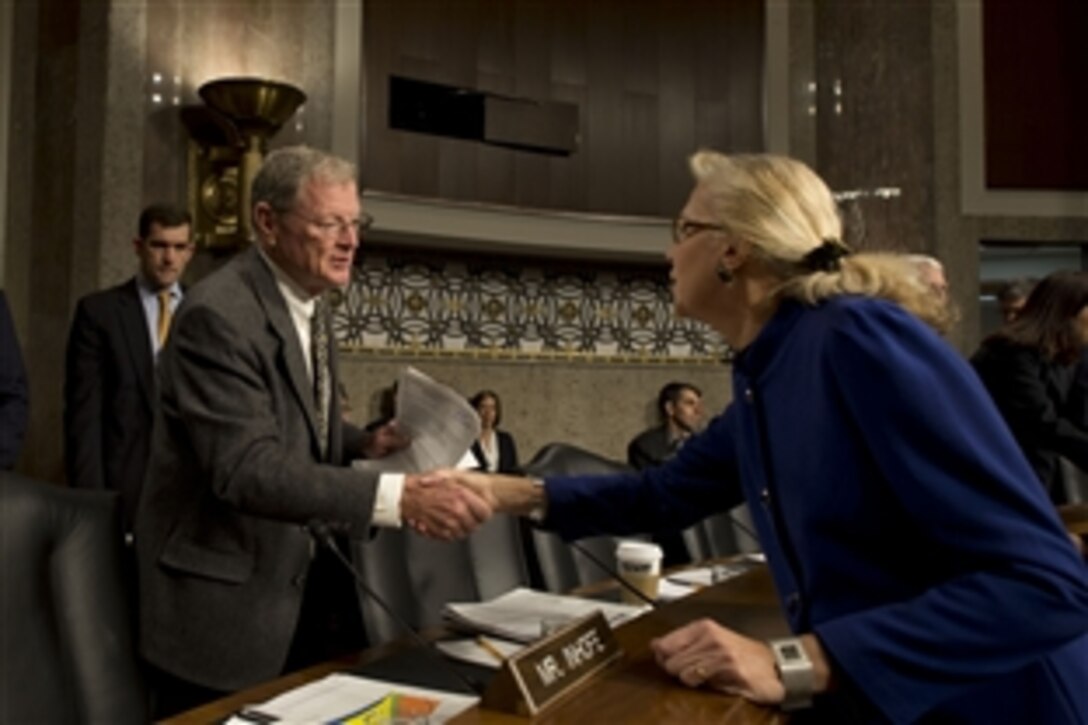 Acting Deputy Defense Secretary Christine H. Fox, right, greets U.S. Sen. James M. Inhofe of Oklahoma before testifying to the Senate Armed Services Committee in Washington, D.C., Jan. 28, 2014. Fox addressed the current budget environment and the possible requirement to slow the rate of growth in military compensation.  