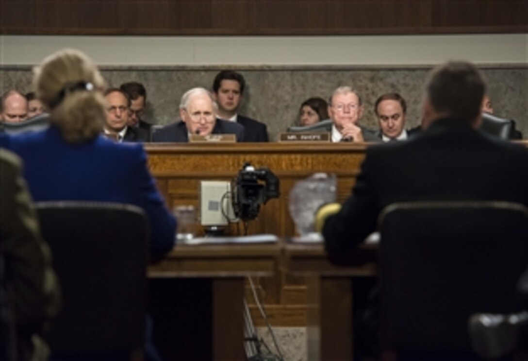 U.S. Sens. Carl Levin of Michigan, left, and James M. Inhofe of Oklahoma listen as Navy Adm. James A. Winnefeld Jr., vice chairman of the Joint Chiefs of Staff, and Acting Deputy Defense Secretary Christine H. Fox testify before the Senate Armed Services Committee in Washington, D.C., Jan. 28, 2014. Winnefeld and Fox addressed the current budget environment and possible requirement to slow the rate of growth in military compensation.