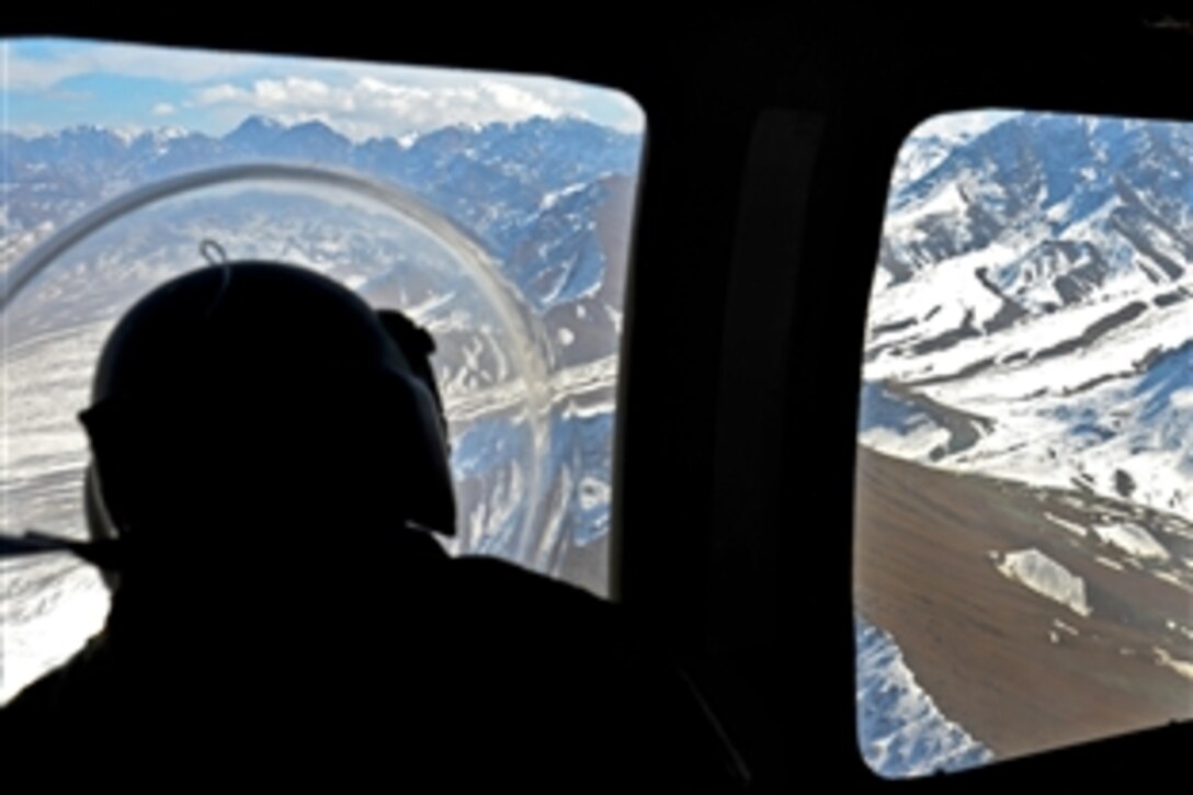 U.S. Army Sgt. Mary McCay looks out the window of a UH-60 Black Hawk helicopter as she heads to pick up a soldier during a medical transportation mission on Forward Operating Base Ghazni, Afghanistan, Jan. 26, 2014. McCay, a health care specialist, is assigned to 101st Airborne Division's 159th Combat Aviation Brigade.